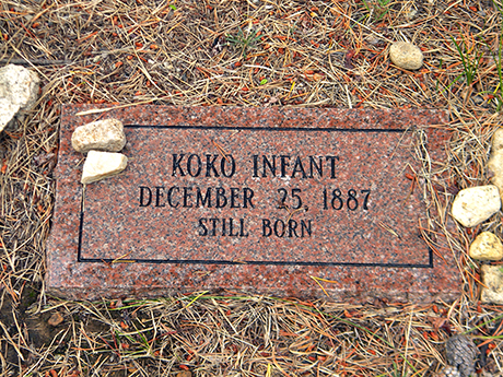 Close up view of the modern replacement marker showing “Koko Infant December 25, 1887 Still Born”.