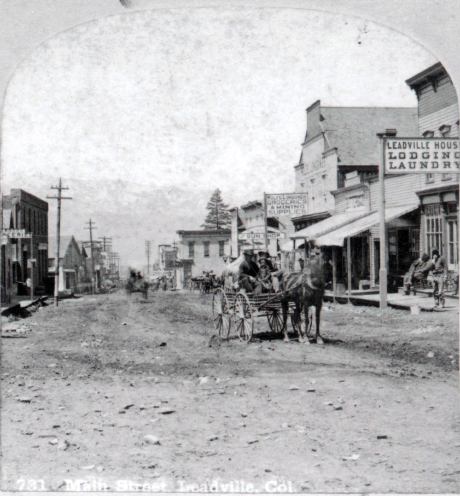 This right side of a stereoview card, produced by Roberts & Fellows, shows the view facing west on Main Street, which was later renamed as East 3rd Street.