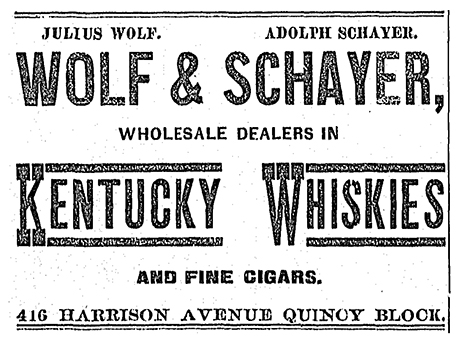 Advertisement for Wolf & Schayer “Wholesale Dealers in Kentucky Whiskies and Fine Cigars”.